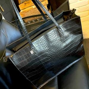 Black beis work bag. Lots of room for everything. Hooks onto luggage handles.